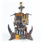 Steampunk robot sculpture made from scrap metal with yellow/orange panels on a jagged, spiked base.